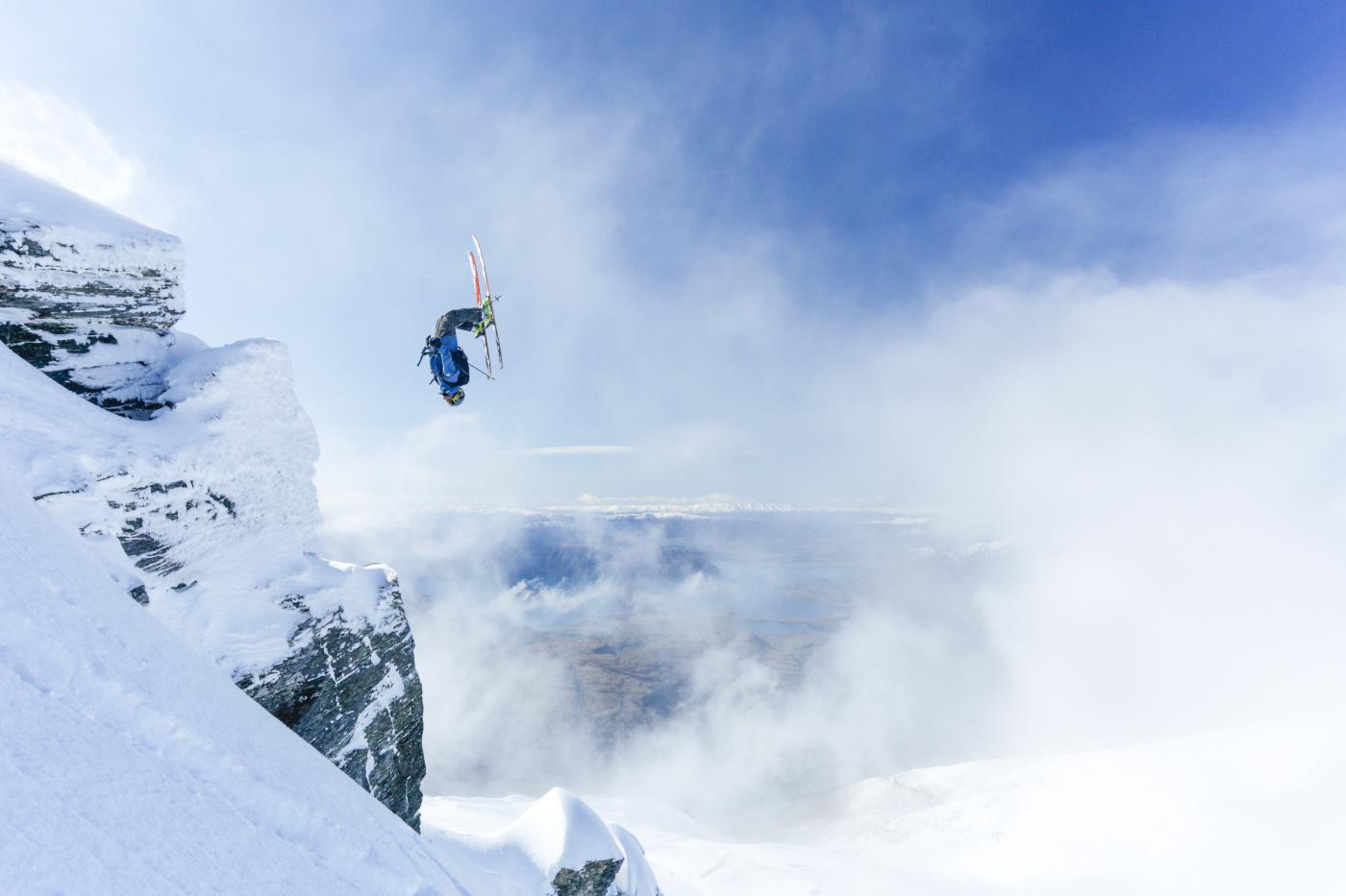 Person doing backflip over rocks at Treble Cone