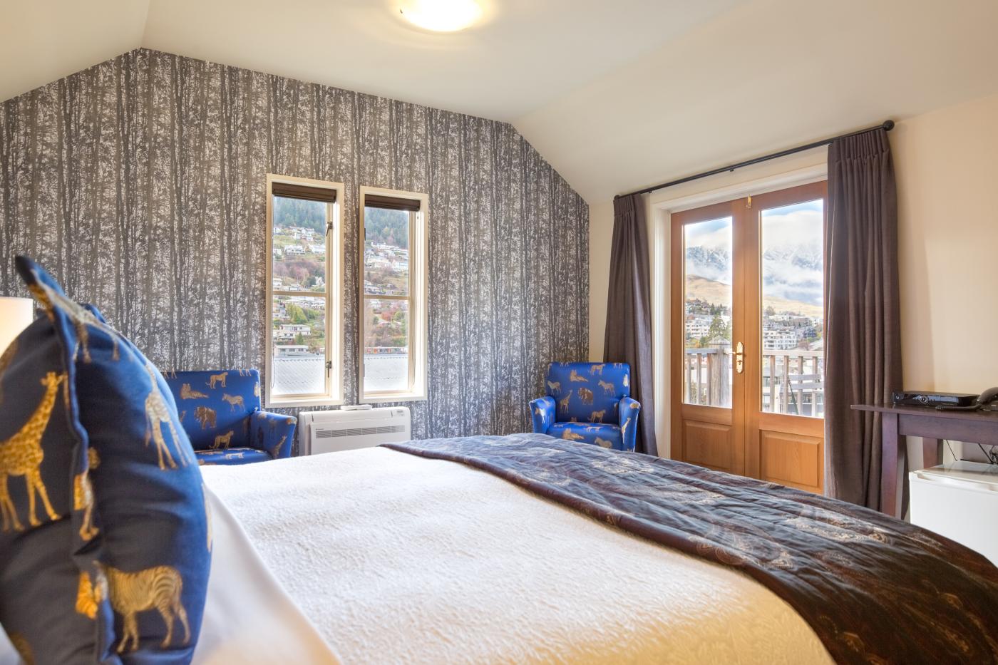 Cosy room at the The Dairy Private Hotel, with views of the Remarkables mountains covered in snow.
