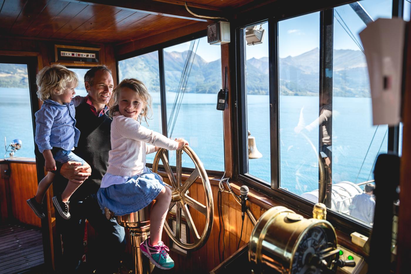 Young girl steering the TSS Earnslaw Steamship