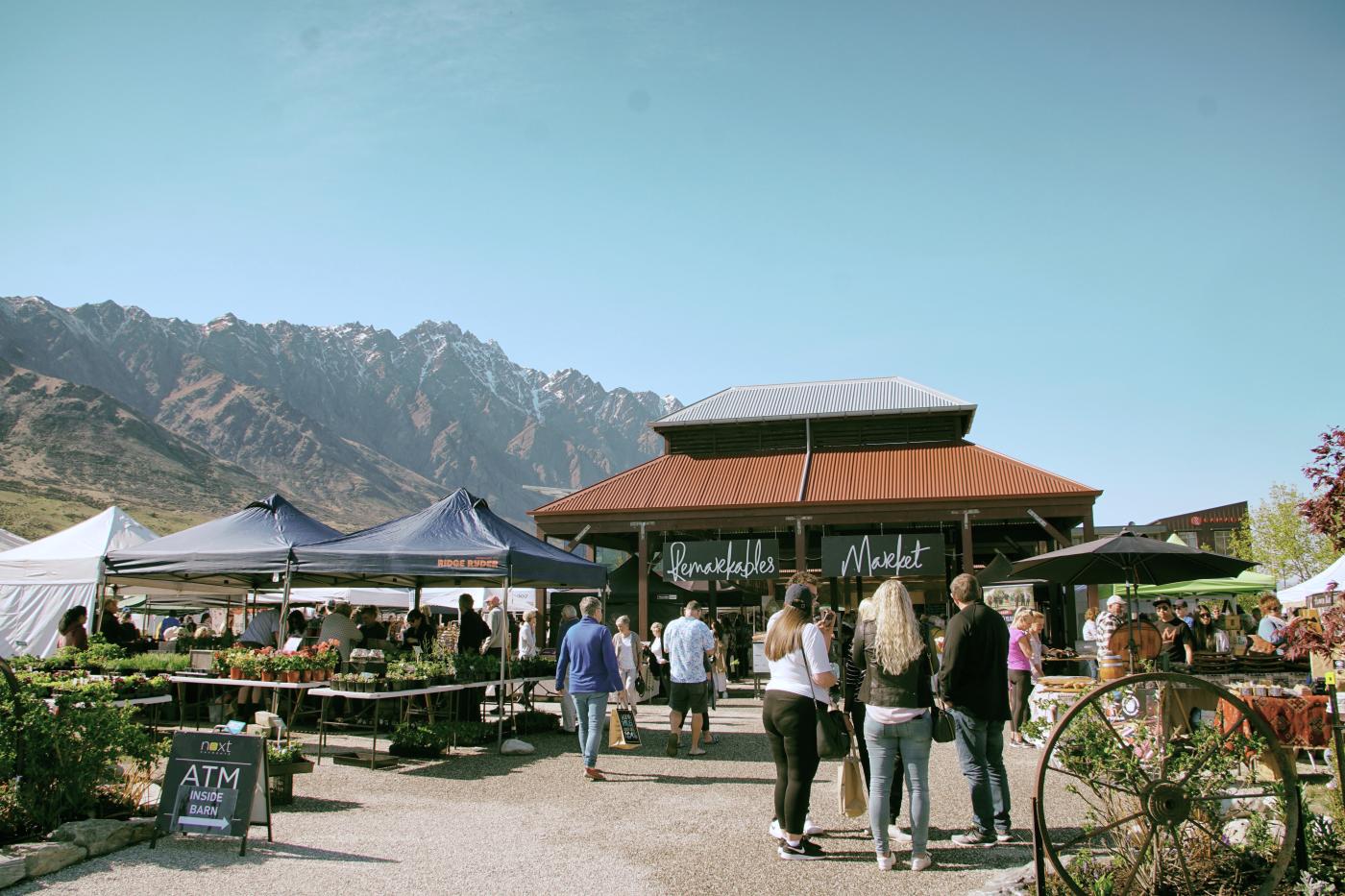 People at The Remarkables Market with views of the Remarkables mountains in the background