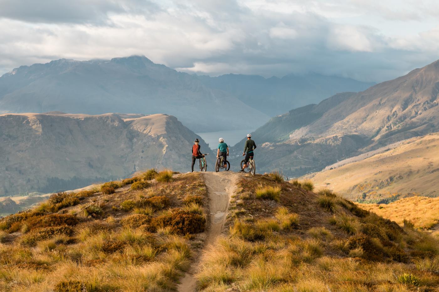 Riders overlooking Queenstown at Rude Rock, Coronet Peak