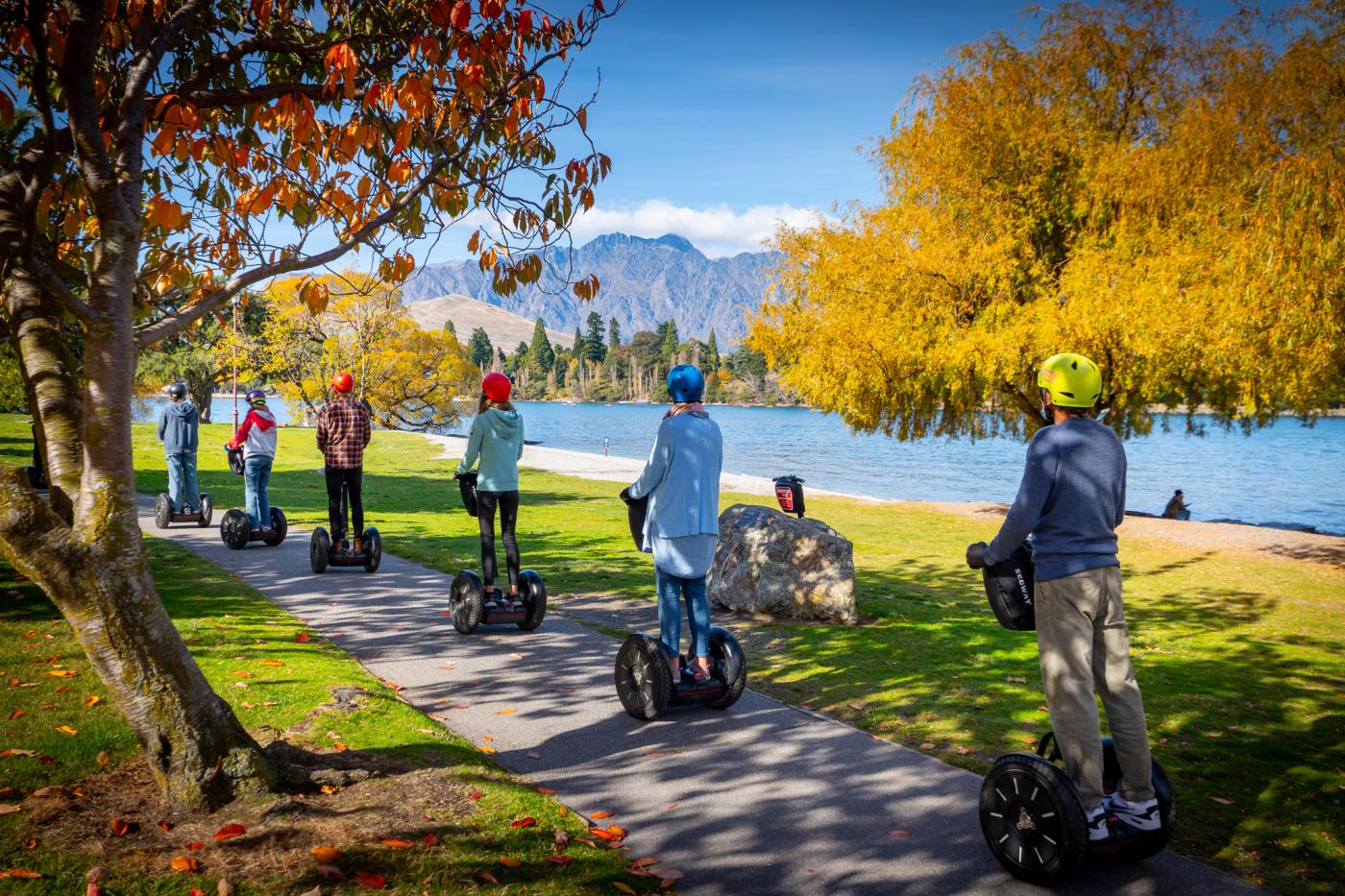 People on segways with mountains in the background