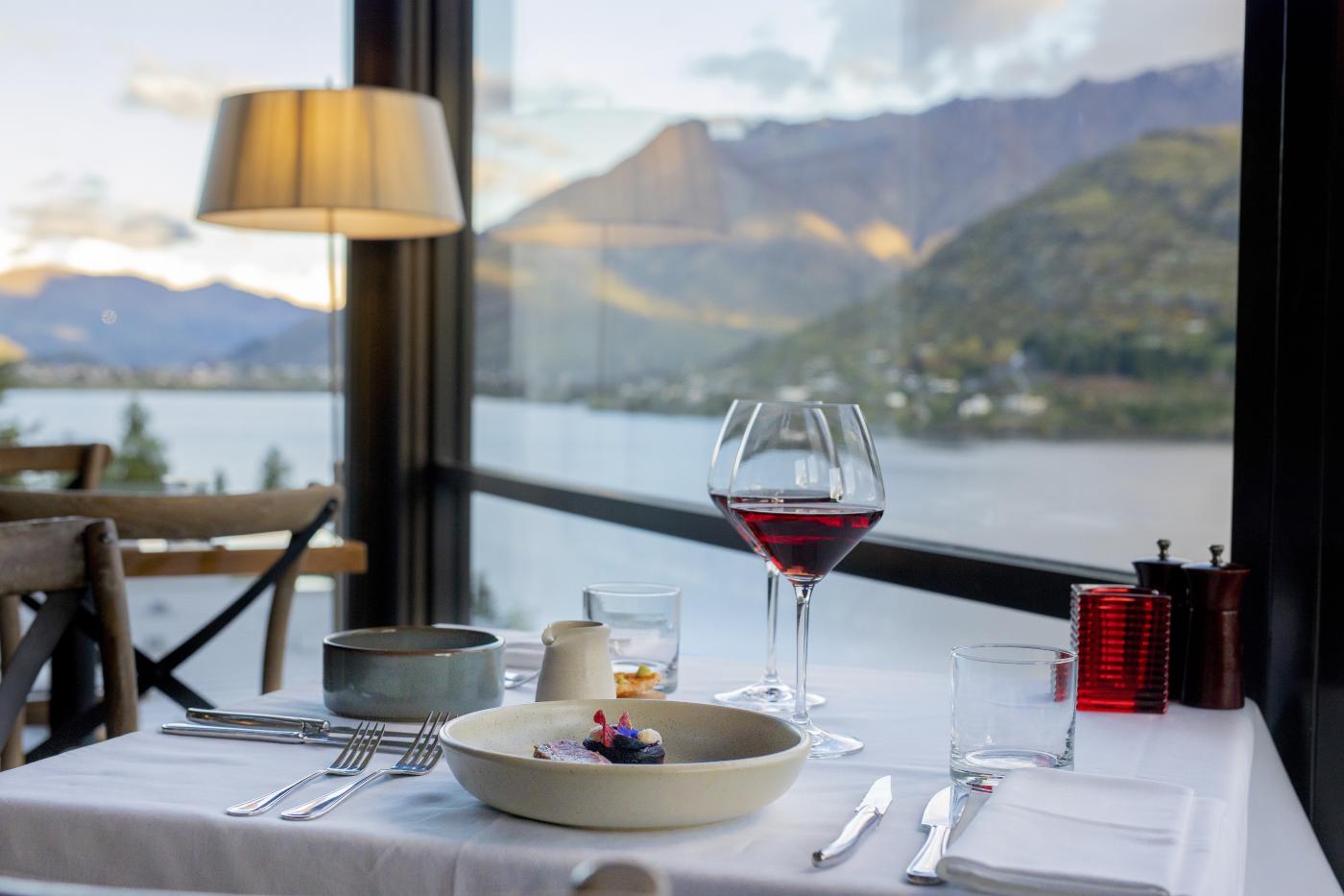 Red wine and food with view of the Remarkables mountains in the background