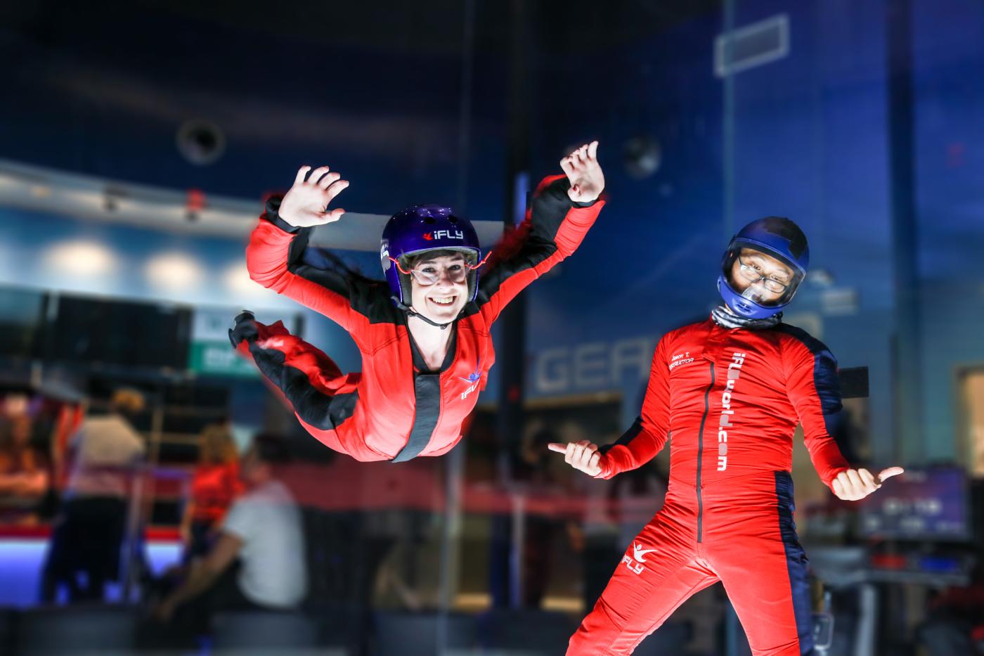 Lady flying next to instructor at iFly