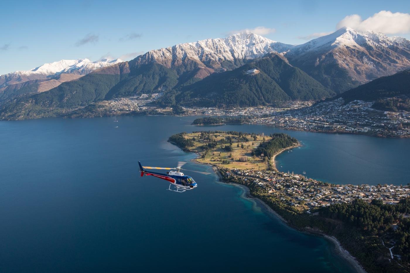 Helicopter flying over Queenstown Lake