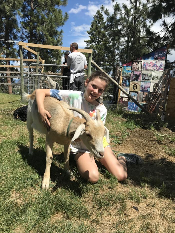 Petting a resident goat at Off The Grid Organic Winery