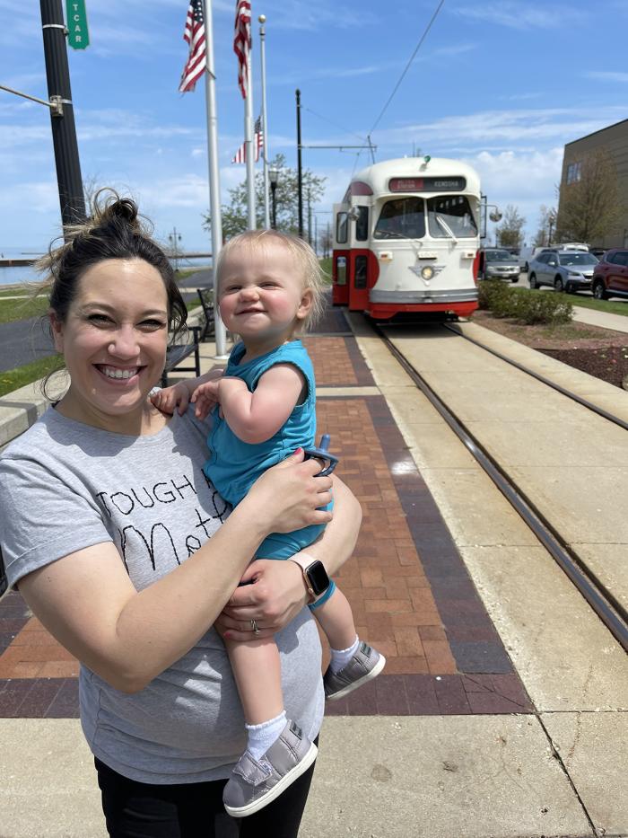 child and adult near Electric Streetcar in HarborPark