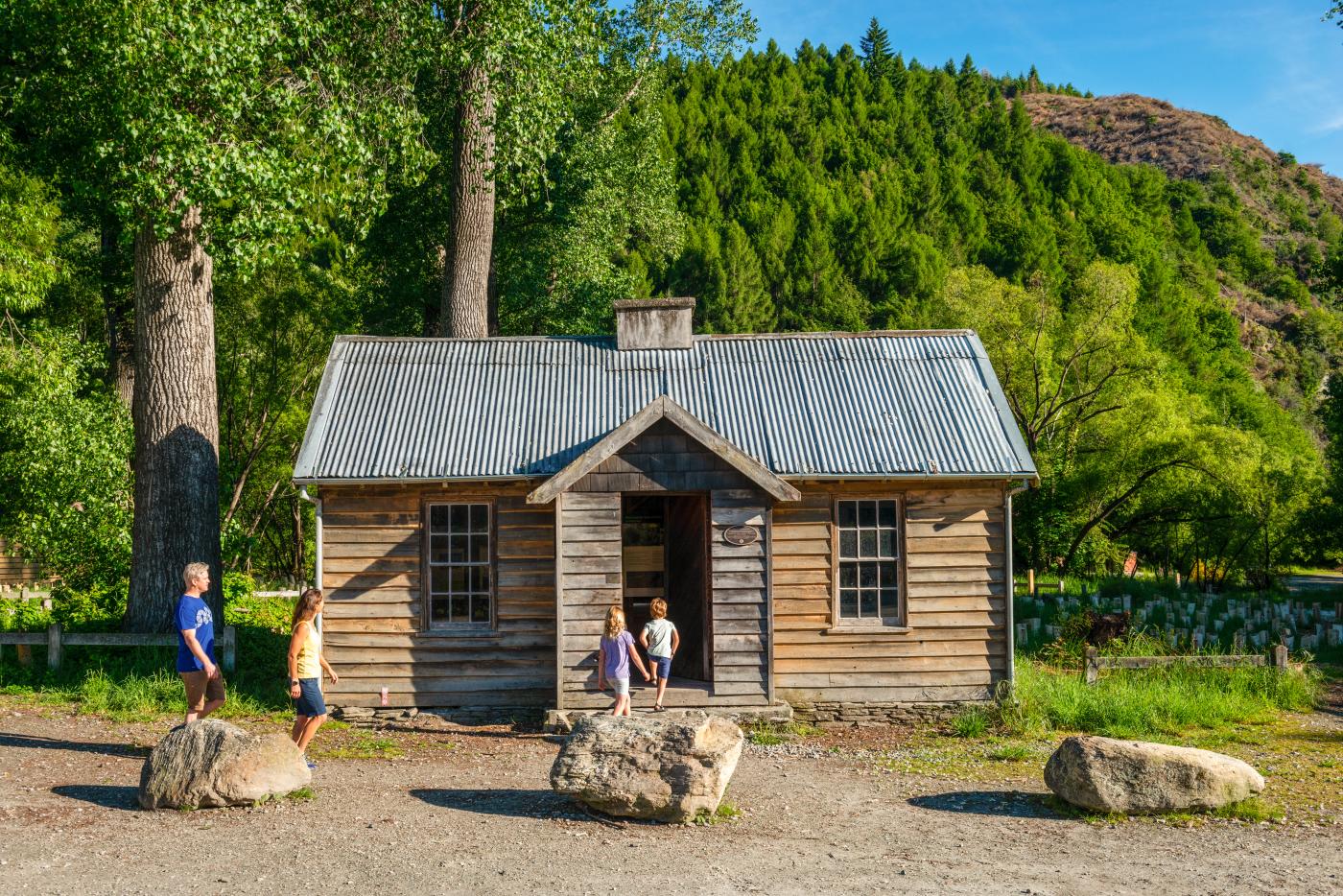 Family in front of the historic Arrowtown Police Hut