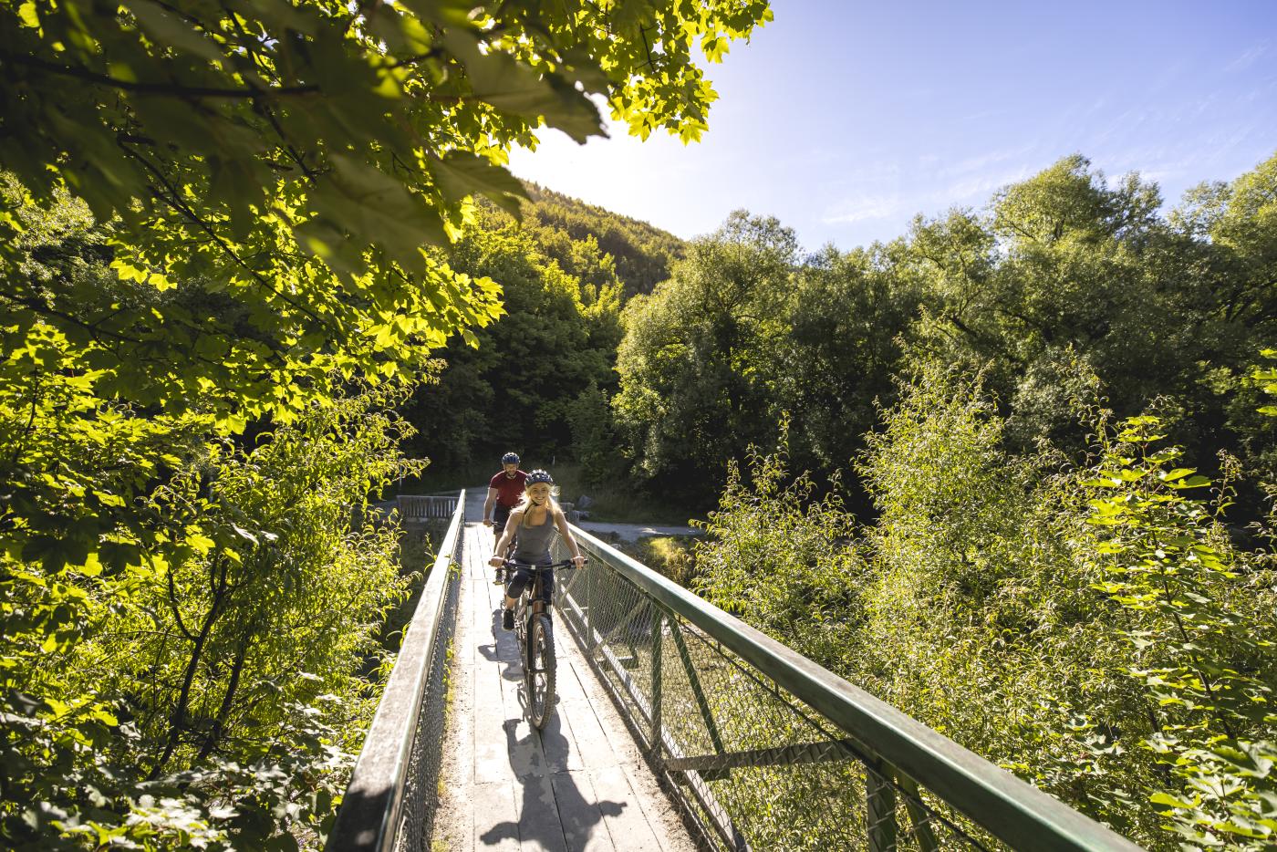 Cyclists biking in Arrowtown during summer