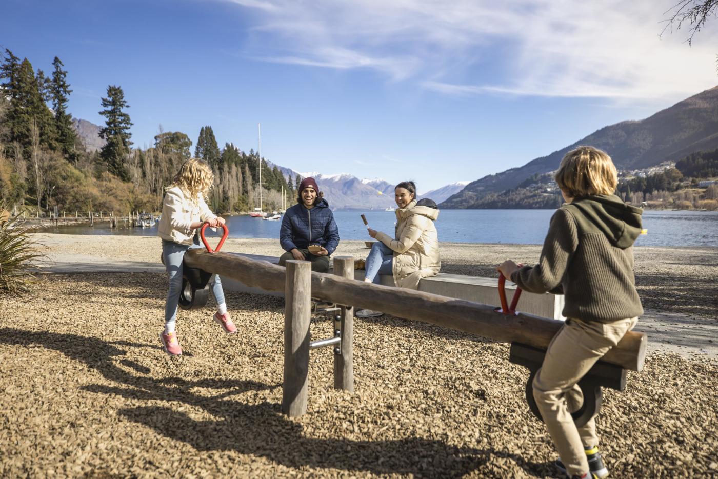 Family playing on a playground in winter