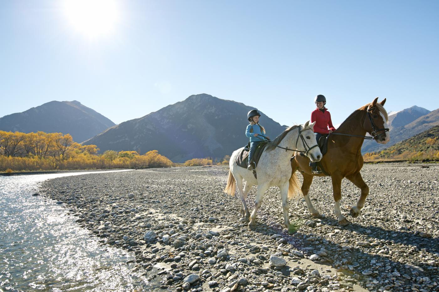 Young girl and mum riding horses in Glenorchy