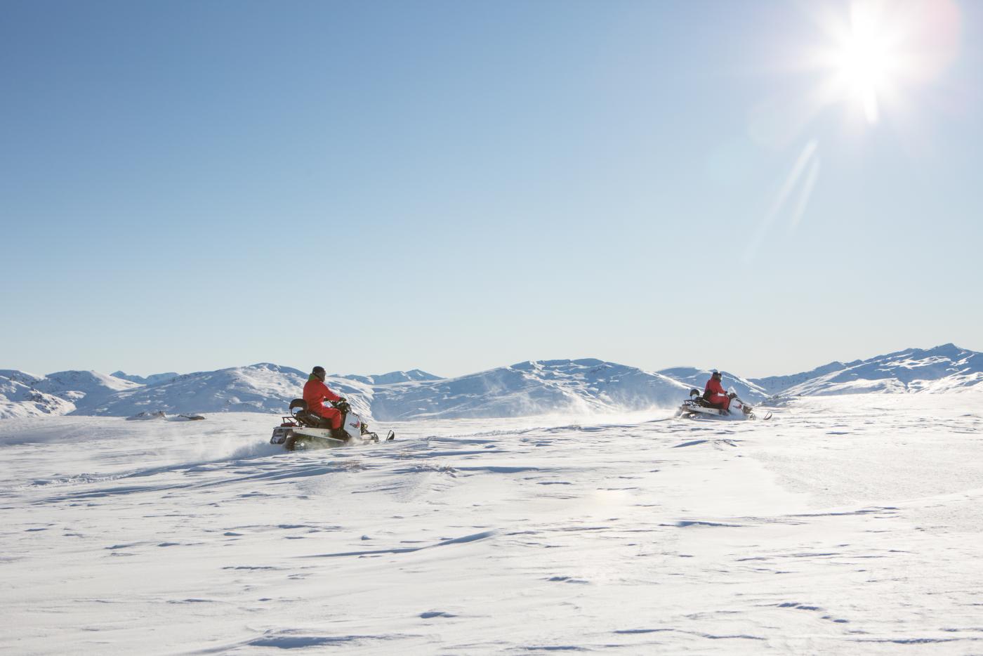 Two people snowmobiling