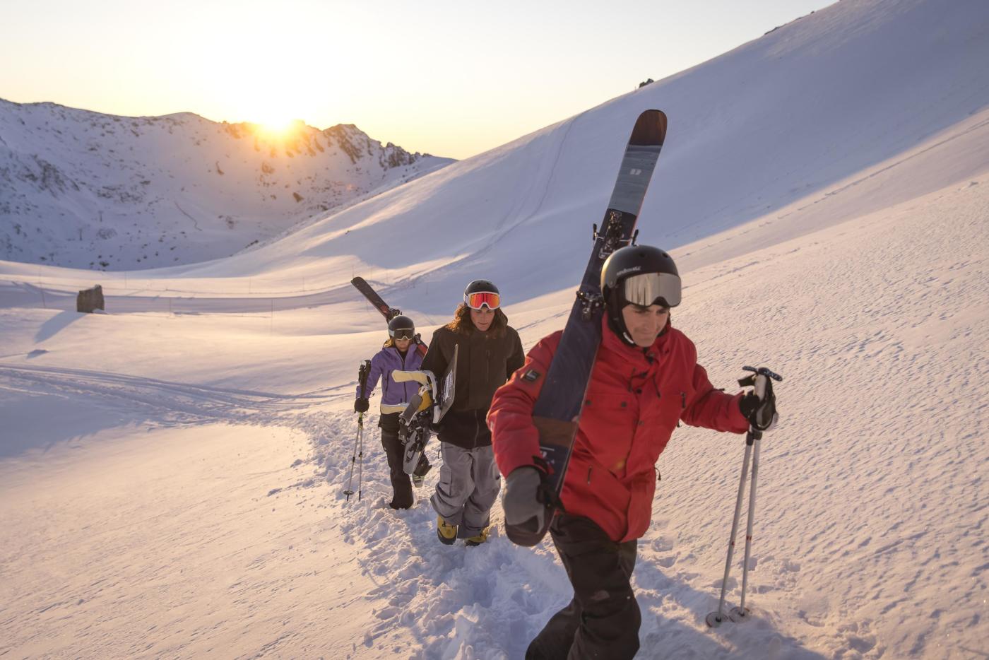 Group of people walking up The Remarkables Ski Area with skis