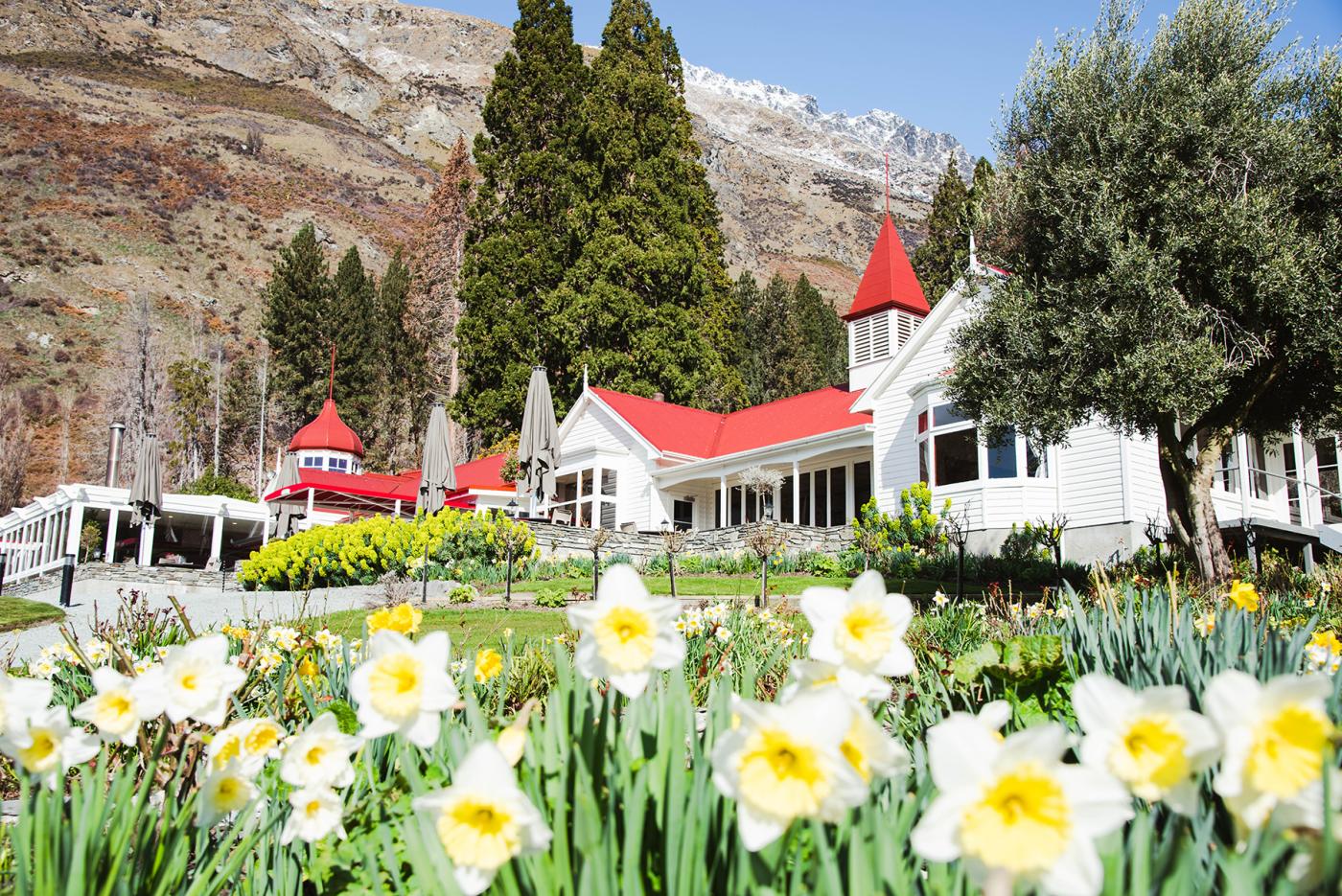 Cute Homestead with daffodils in the foreground