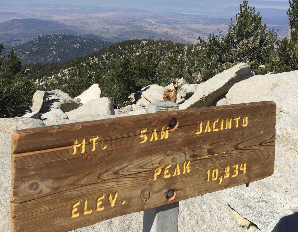 A trail sign marking the summit of Mt. San Jacinto Peak in California