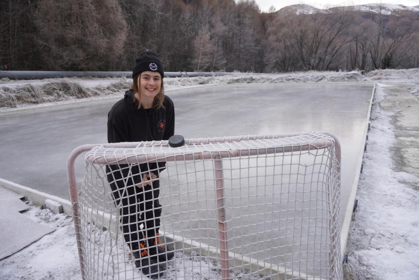 Person standing in front of icerink