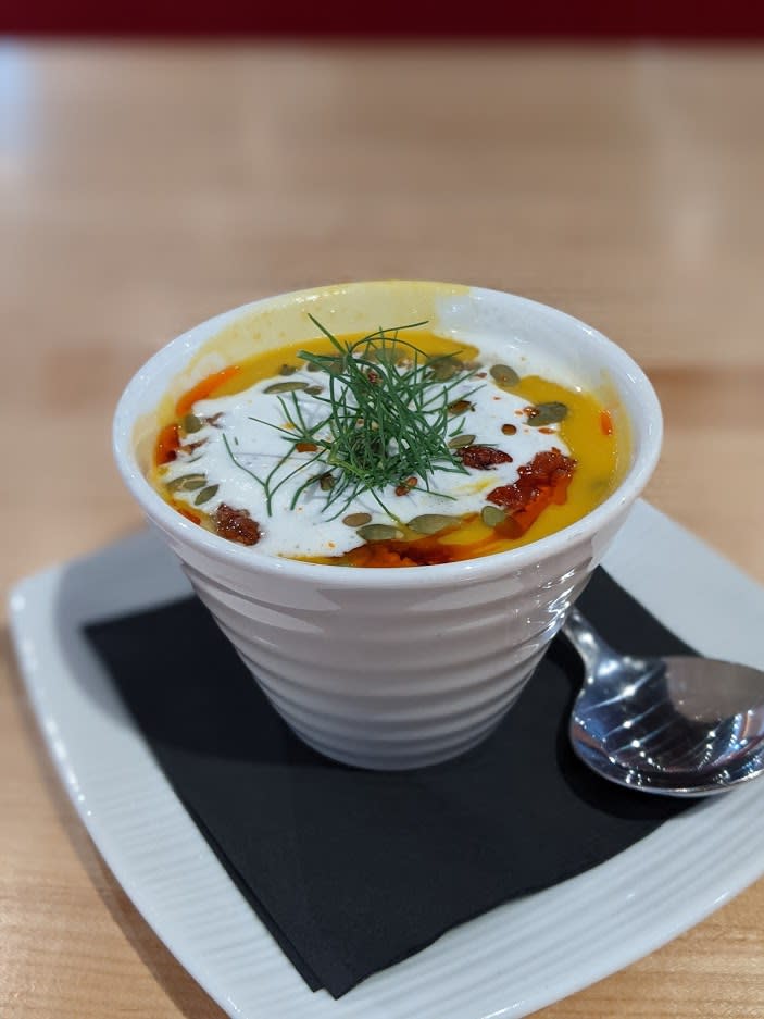 A white bowl filled with butternut squash soup with fennel sour cream on top at Butler's Pantry Cafe in Covington, Ky.