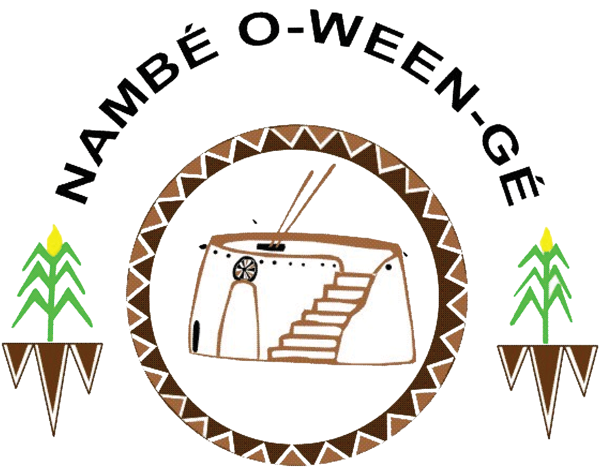 Logo of Nambe O-Ween-Ge featuring a stylized depiction of a traditional adobe structure surrounded by geometric patterns and green corn stalk motifs.