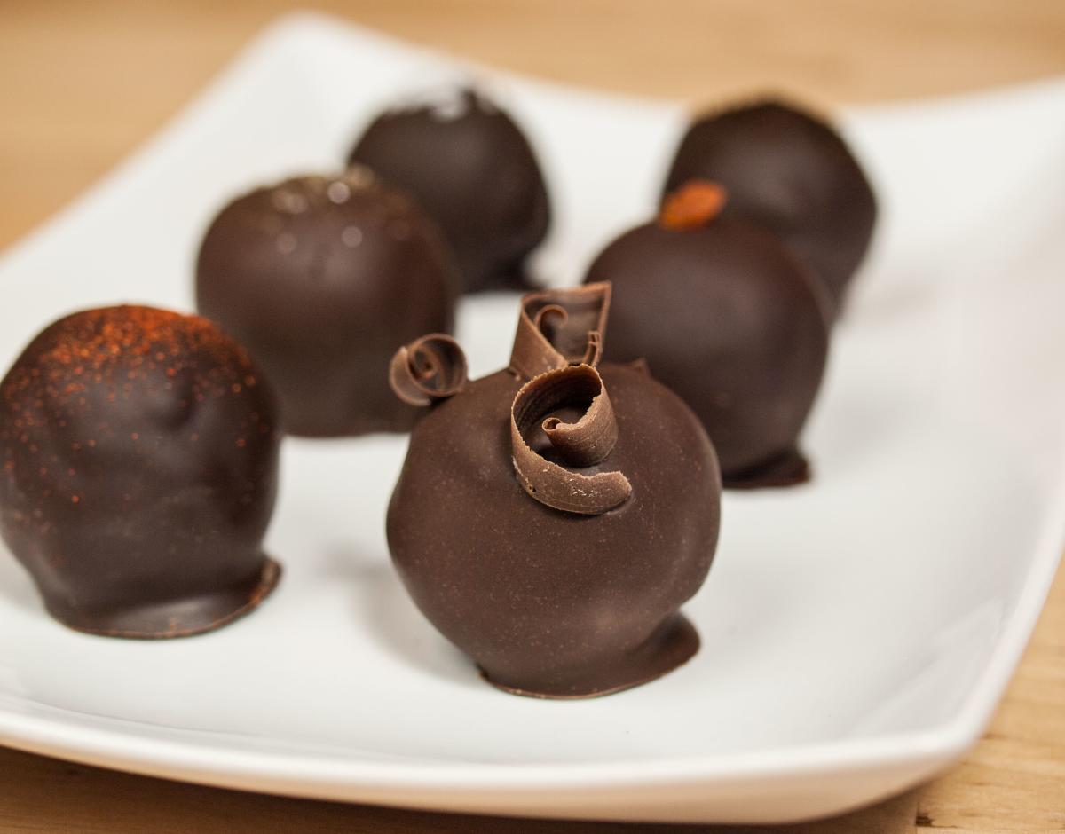 Six chocolate truffles on a plate