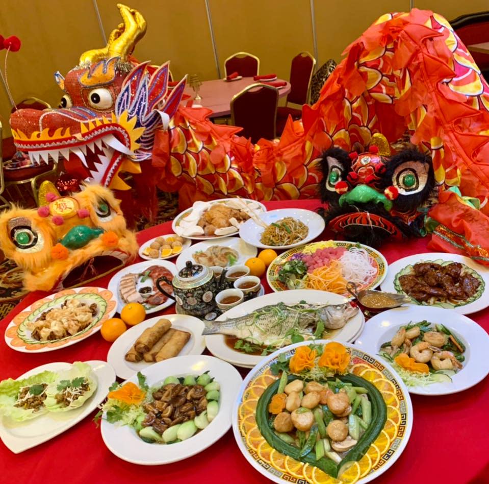 Many plates of Chinese food with a red dragon behind them at Oriental Wok in Northern Kentucky