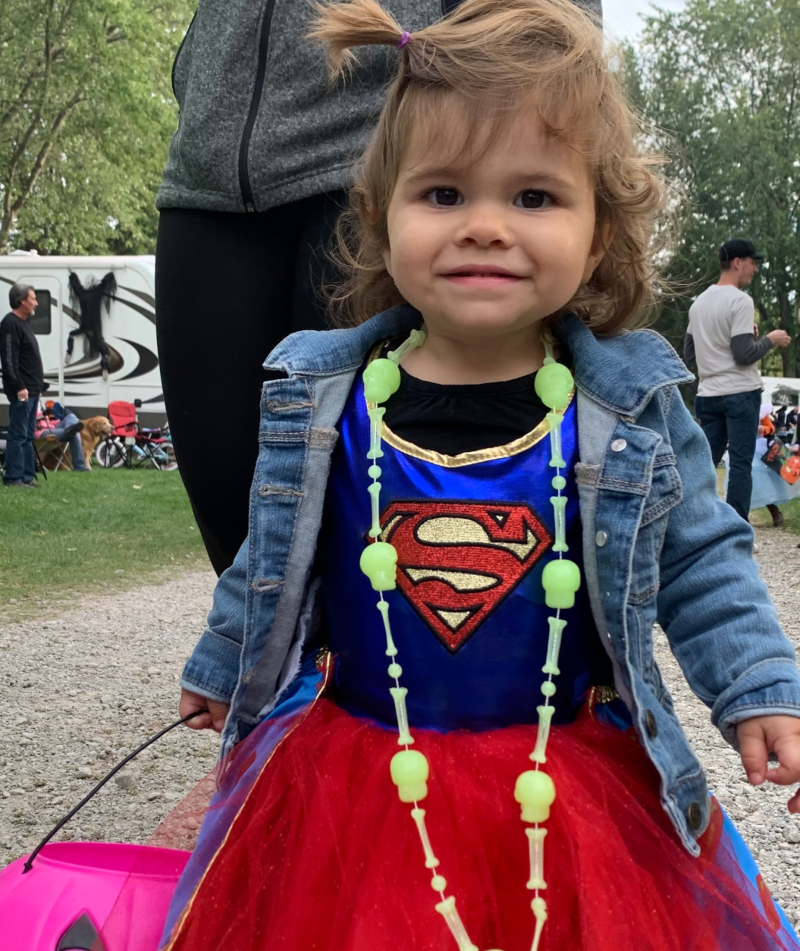 Little girl dressed up like Superwoman for Halloween