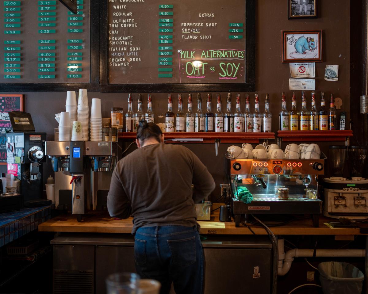 a barista making a coffee at Racy D'Lenes in Eau Claire