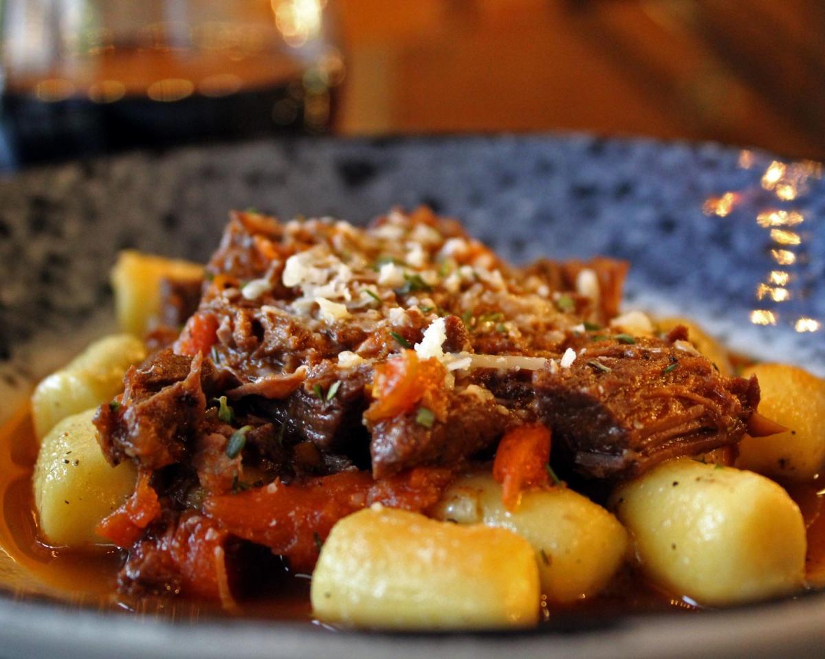 Gnocchi and braised lamb on plate