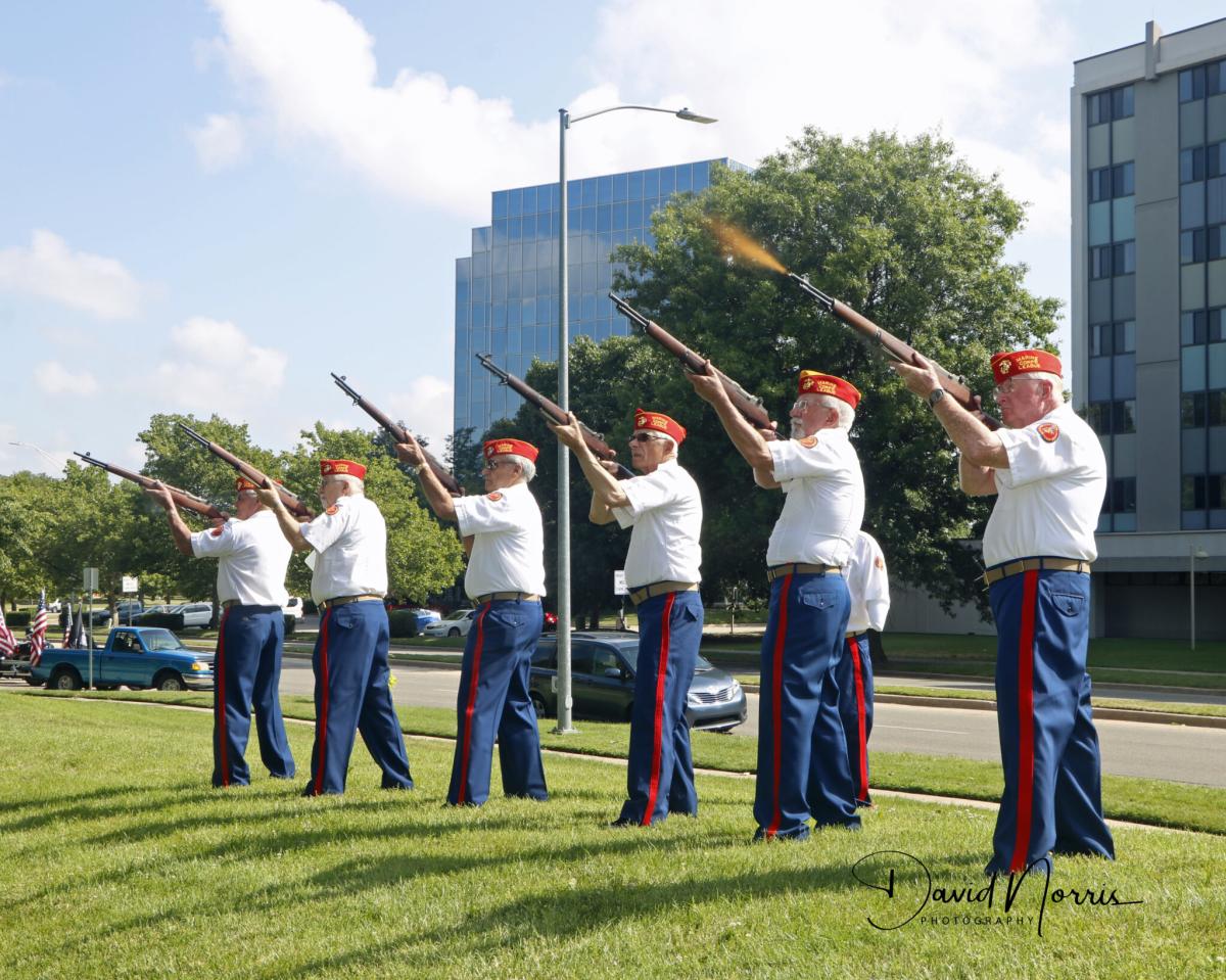 Veterans fire guns during a salute at Veterans Memorial Park