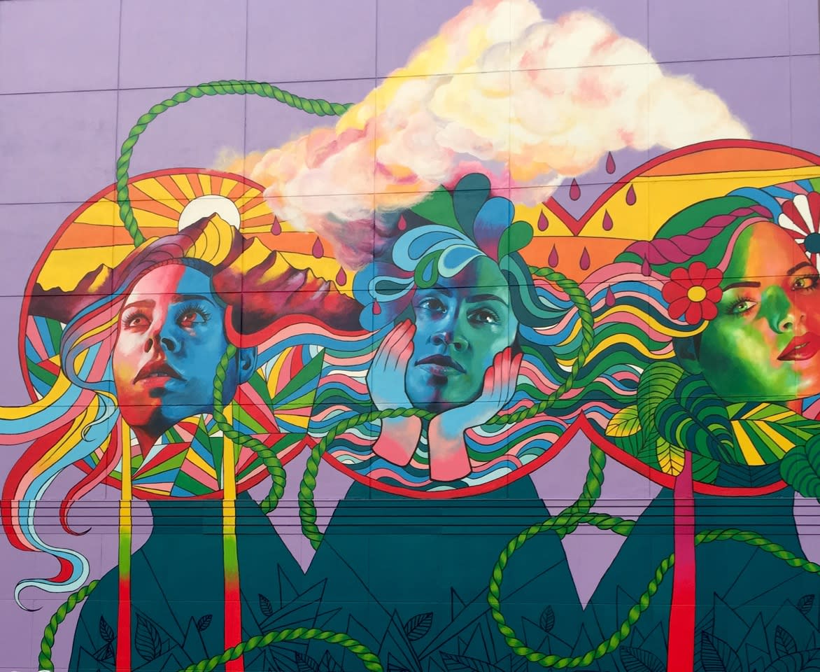 Colorful mural of three women's faces