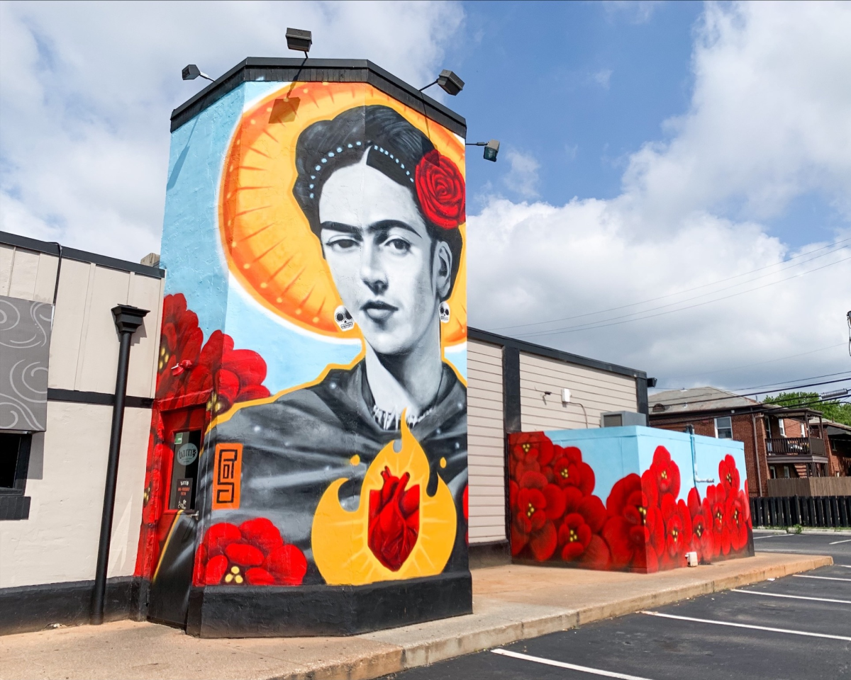 Larger-than-life mural of Frida Kahlo on the side of Barrio restaurant