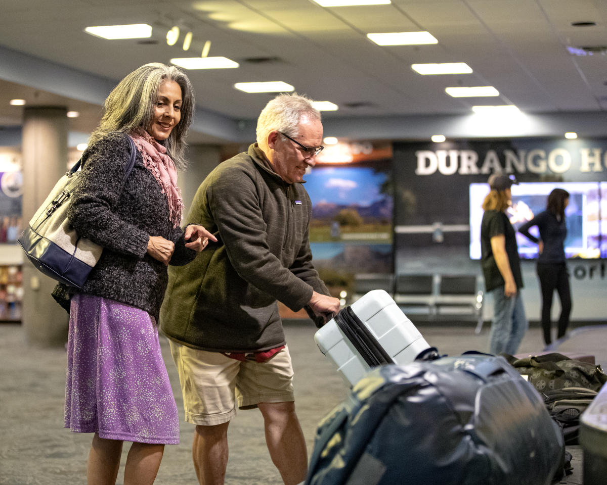 An older couple picking up luggage at the Durango - La Plata Country Airport