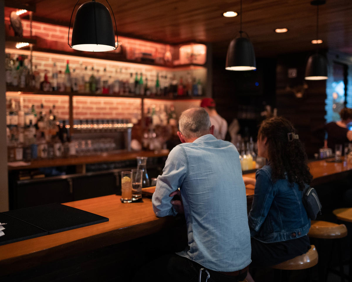 Two guests sitting at the bar at The Lakely