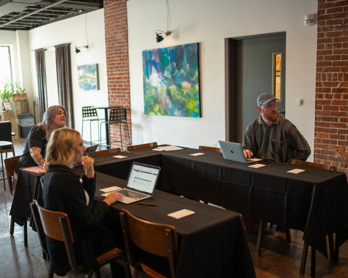 A group of 3 meeting in The Gallery at The Oxbow Hotel