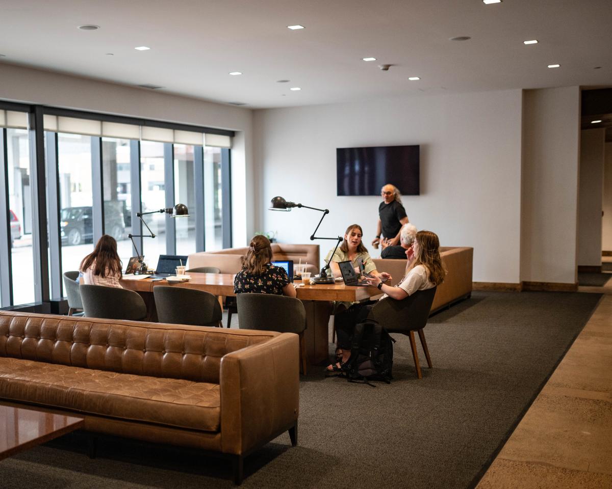 A group of business professionals working at the table in the hotel lobby