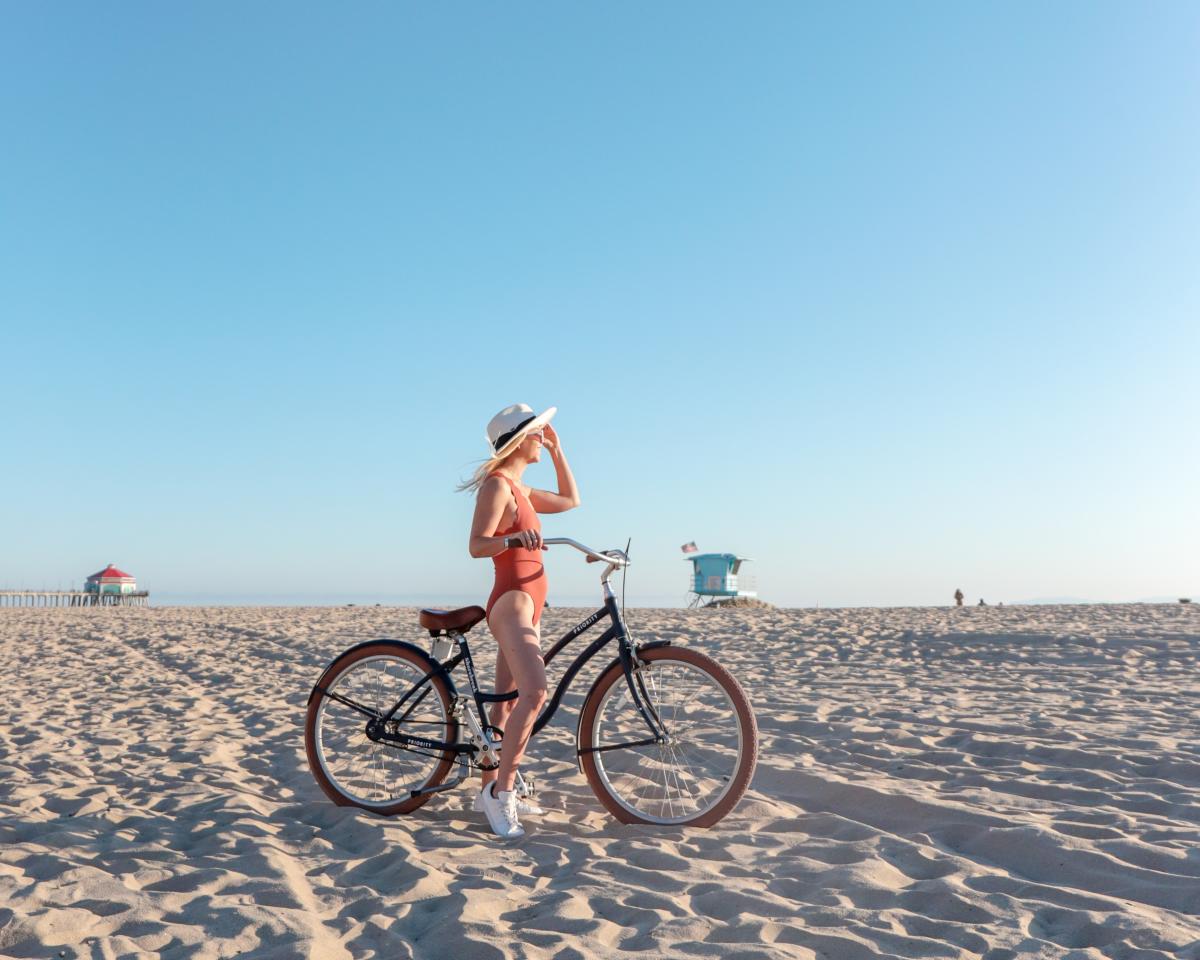 Biking riding at Huntington Beach | Girl on her bike with the Huntington Beach Pier in the background