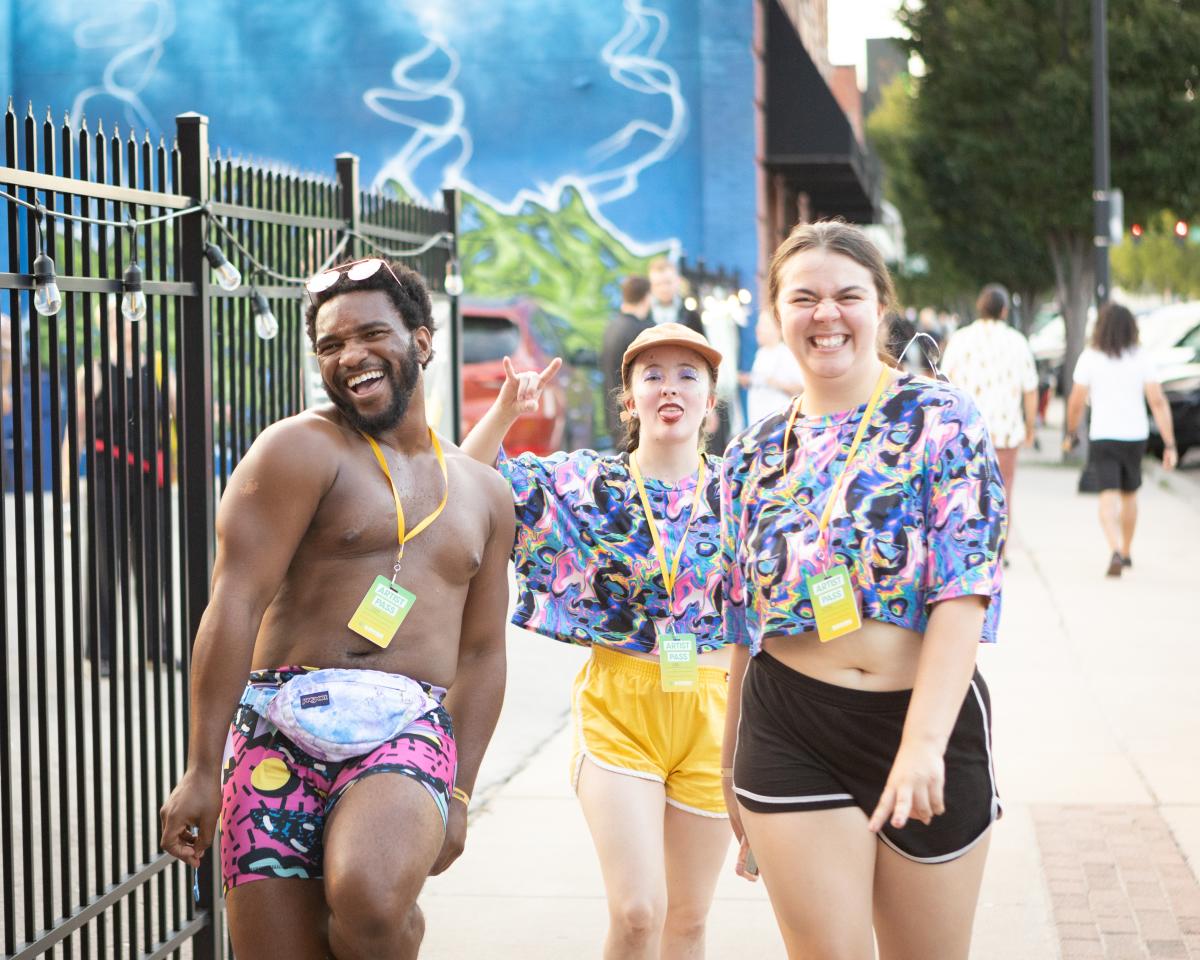 Three young people walk through the streets during Elsewhere Fest in Wichita in 2024.