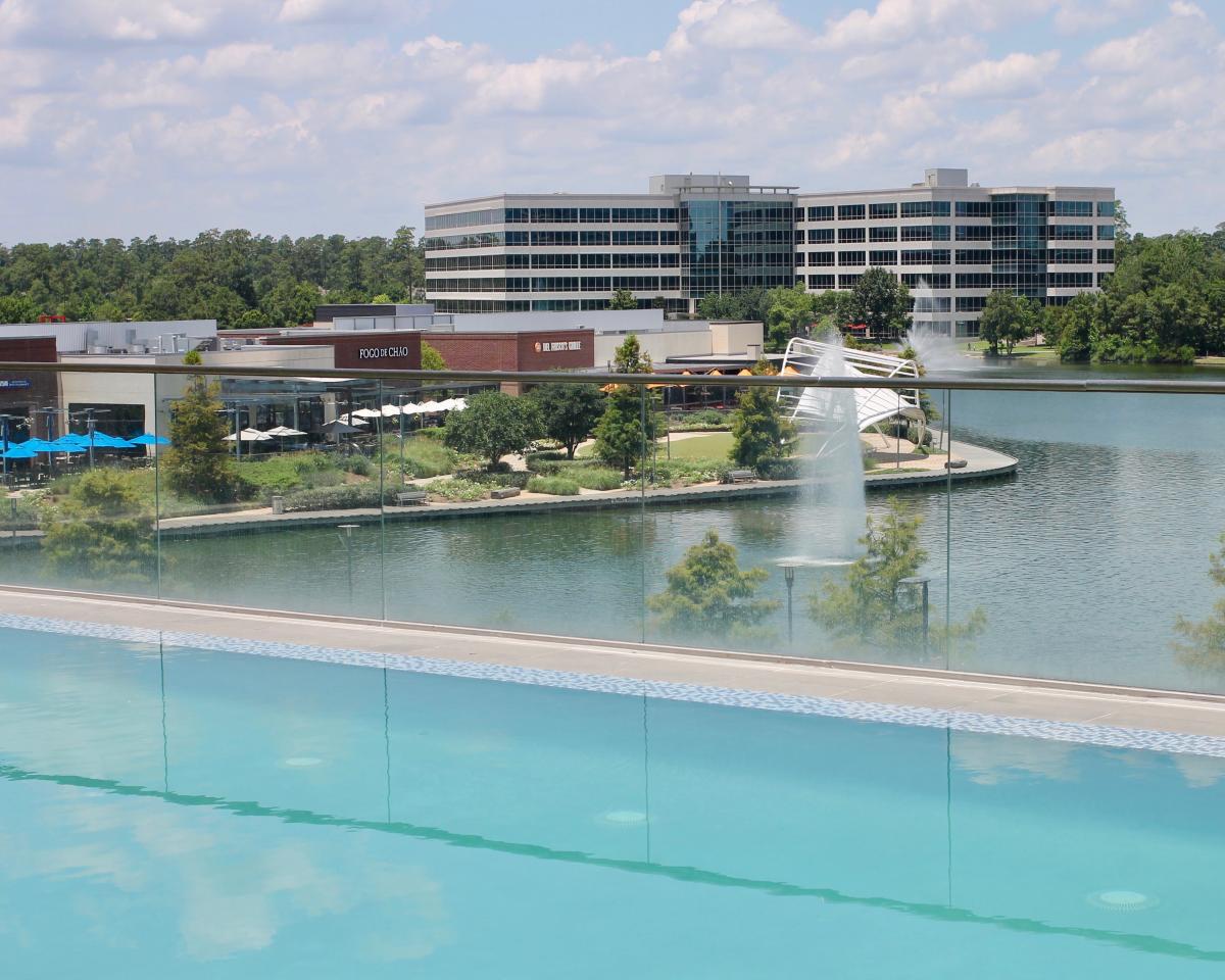 View from infinity pool at Embassy Suites overlooking Restaurant Row and Lake Woodlands at Hughes Landing