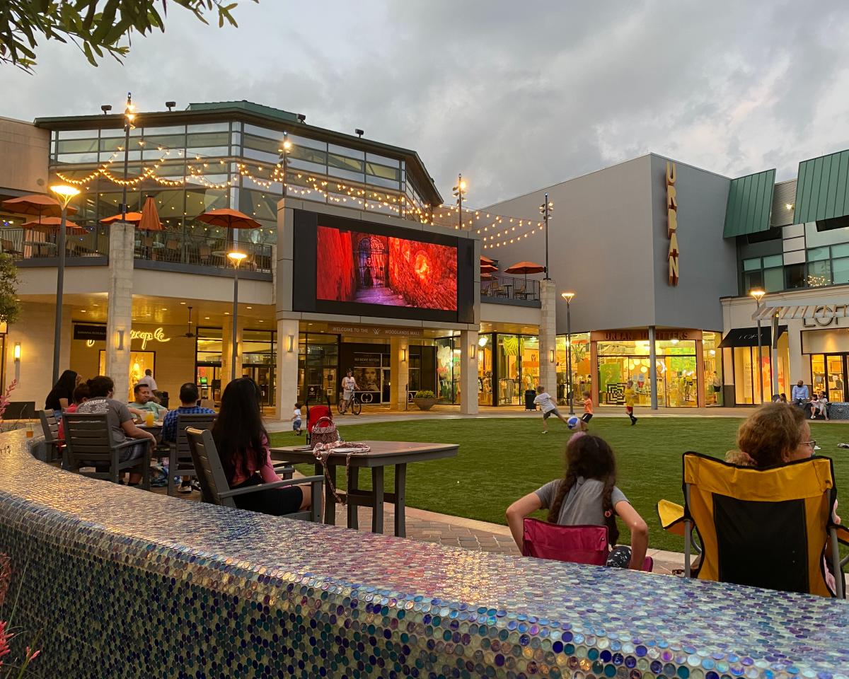 Movie playing on outdoors screen at The Woodlands Mall