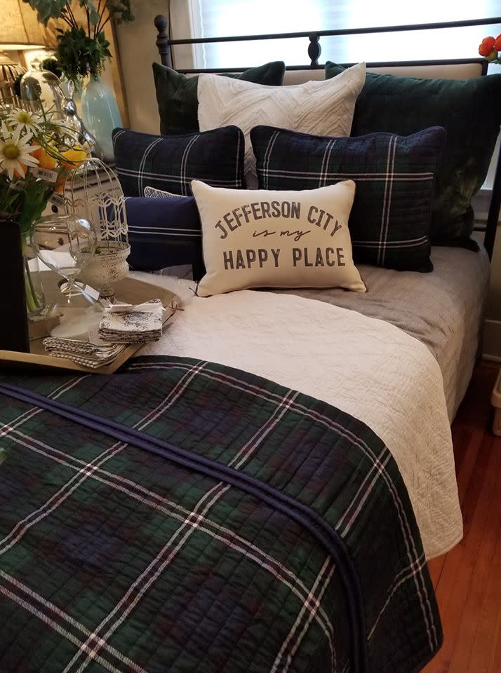 room decorated with plaid comforter and "jefferson city is my happy place" pillow