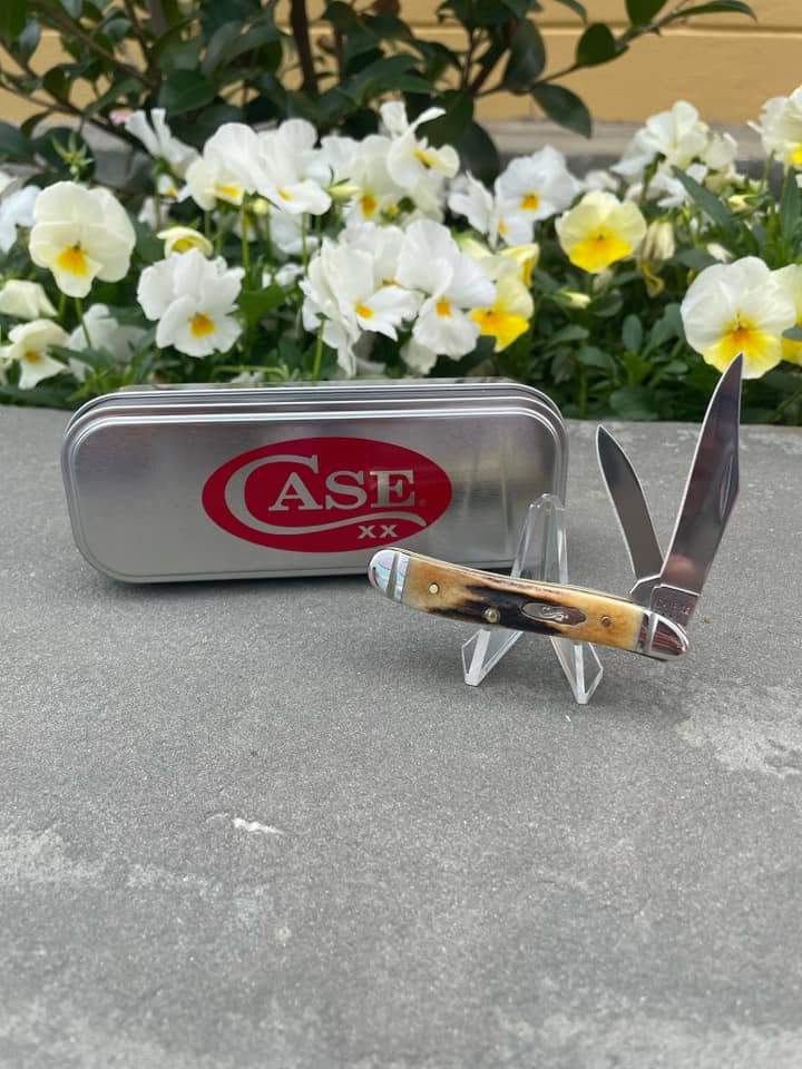 picture of a Case knife from ug white in front of some colorful flowers