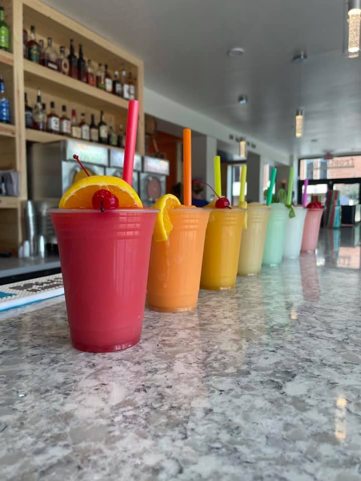 A row of alcoholic slushes in rainbow colors at Frosthaus Covington, Ky.