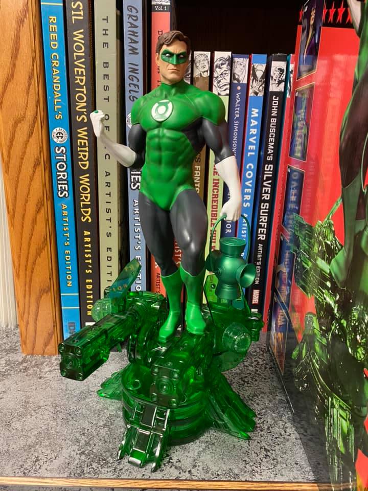 figurine of the green lantern in front of comic book shelf