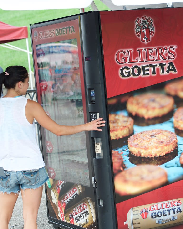 A woman placing an order at the Glier's Goetta Vending Machine