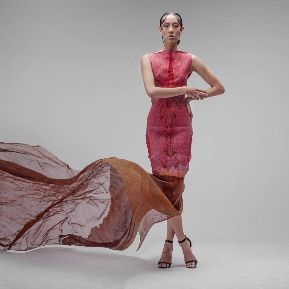 A Celeste Malvar-Stewart's design featuring bright colors and flowing fabric on a model.