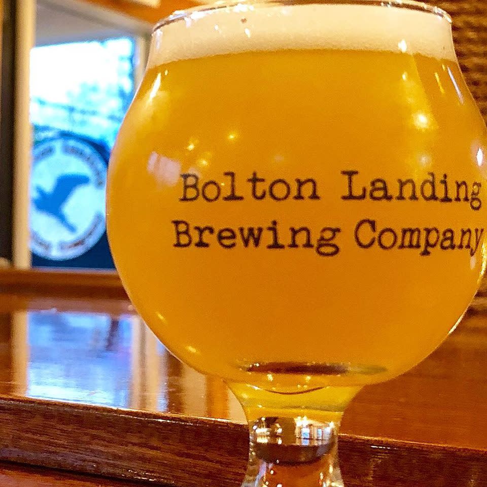 Beer in a branded glass at Bolton Landing Brewing Company