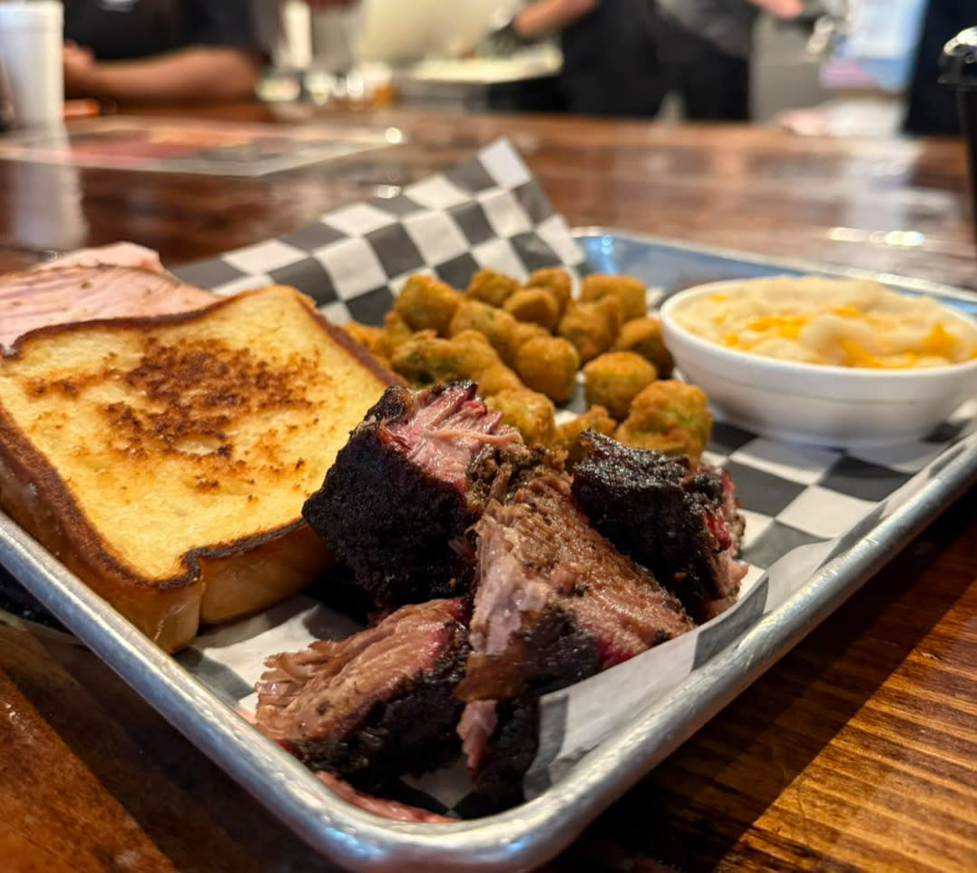 A metal platter of bbq is served at Delano BBQ