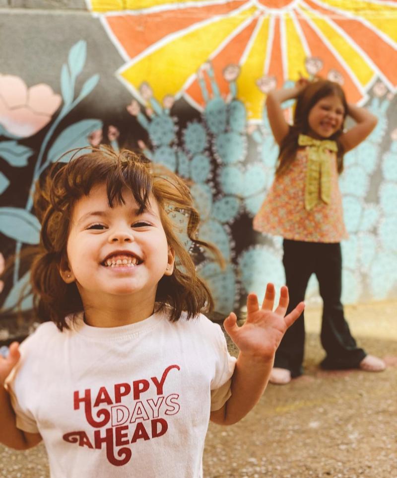 little girls with mural