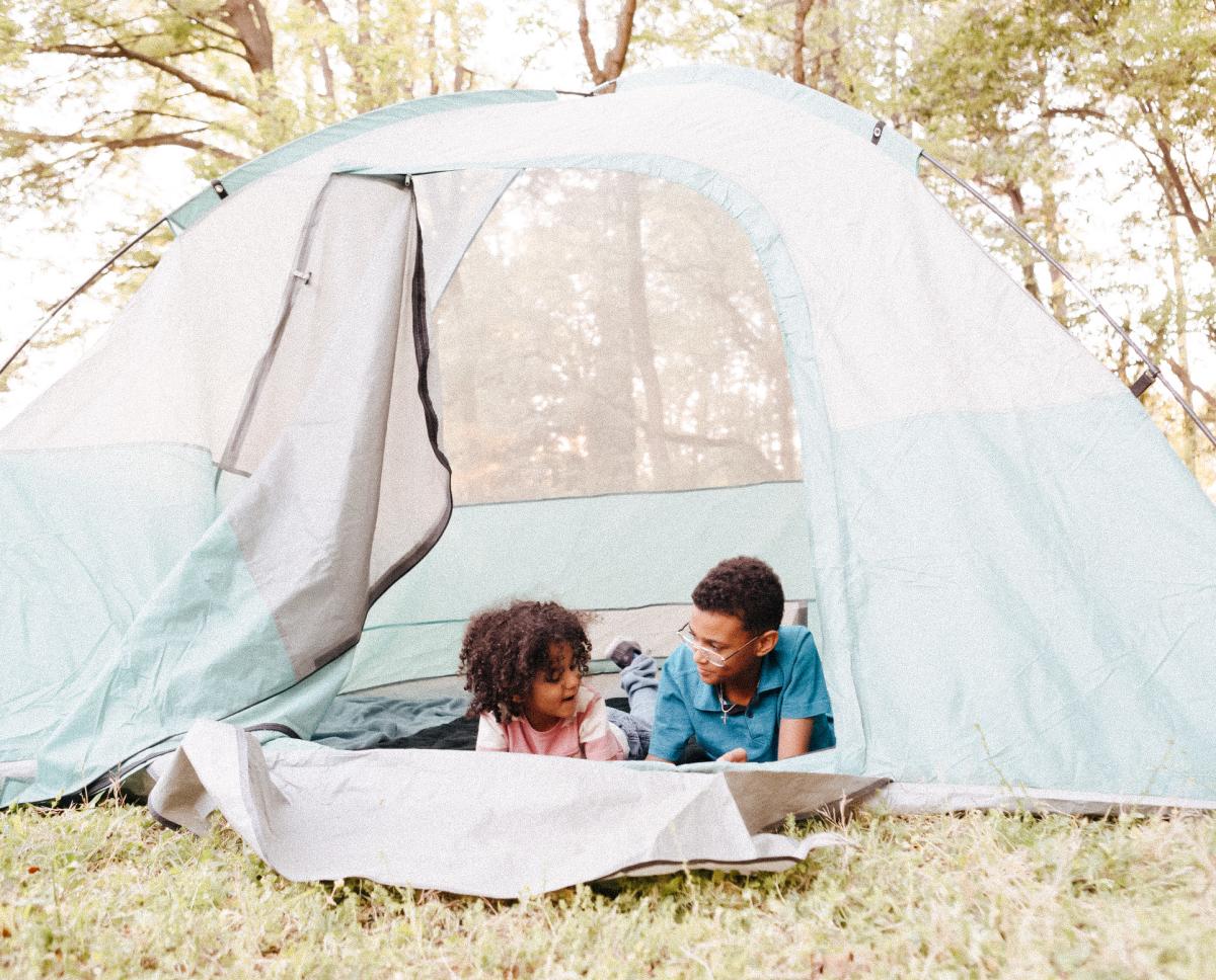 Two Children Camping In A Tent