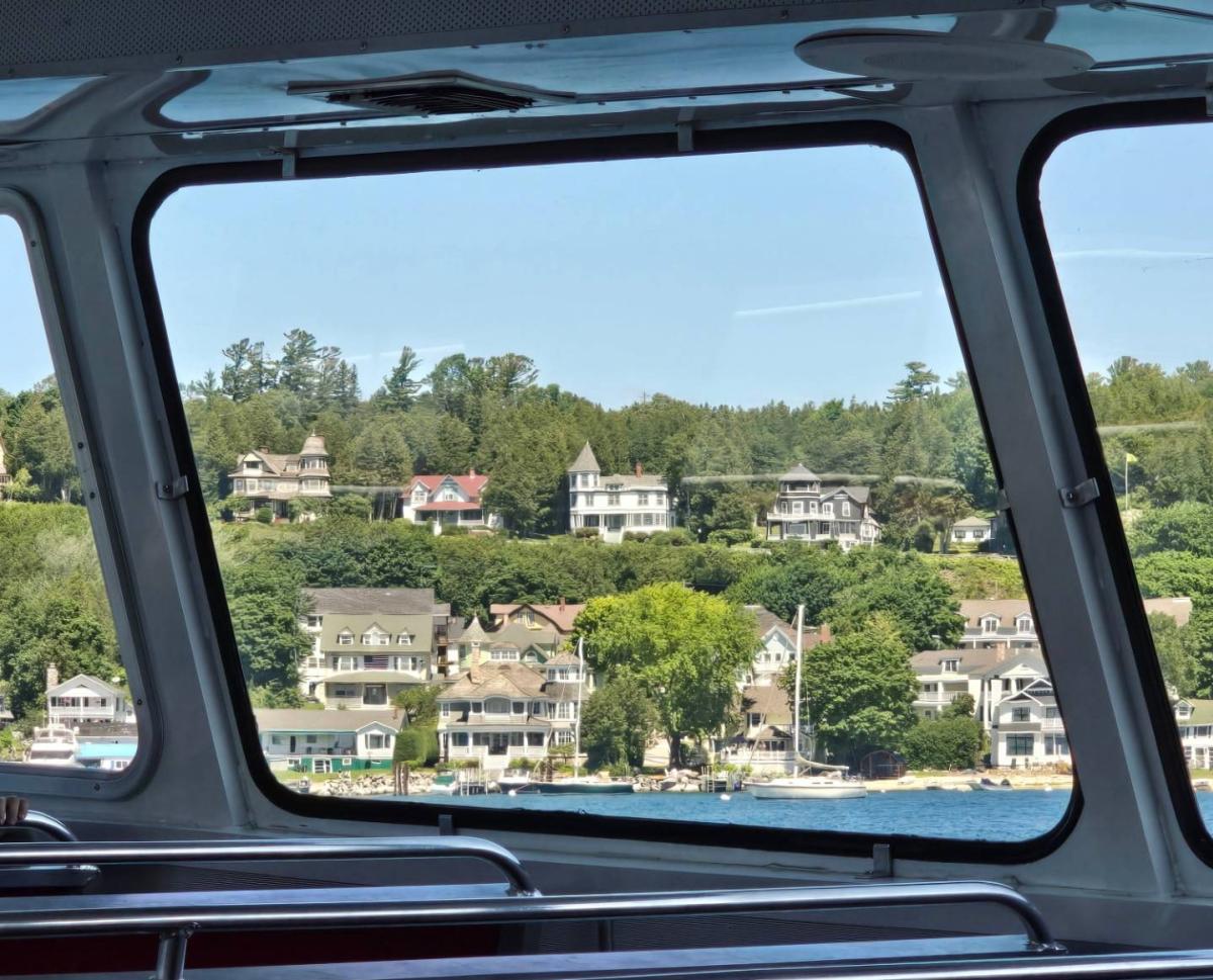 Mackinac Island cottages seen through the window of a ferry boat