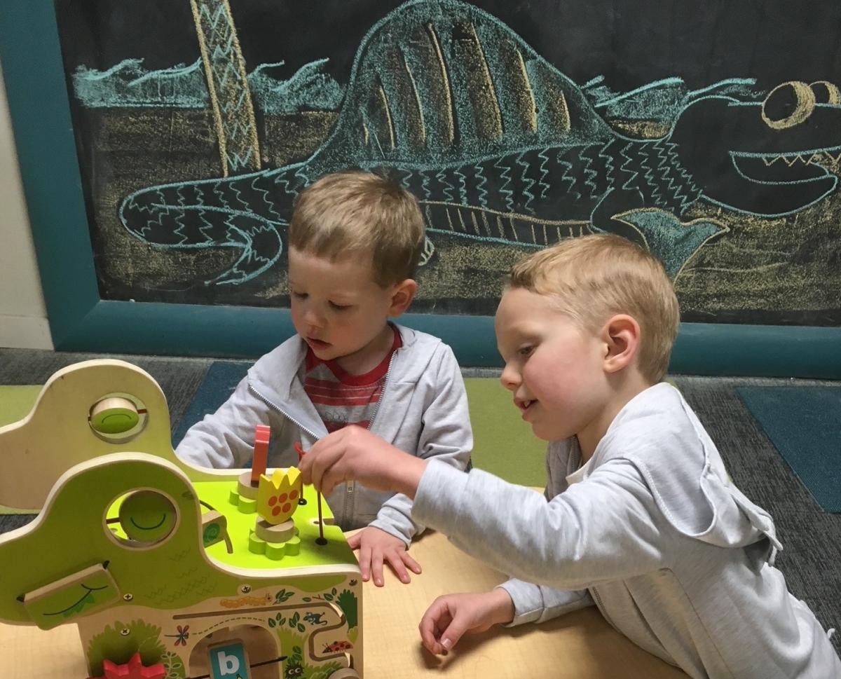 Two boys play on the third floor of the Museum of World Treasures